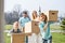 Family with cardboard boxes moving into new house