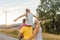 Family carrying child piggyback on summer walk