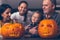 Family carving big orange pumpkin for Halloween