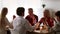 Family Celebrating Thanksgiving Day Praying Together Holding Hands In Kitchen