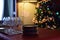 Family celebration table with champagne glasses and stacked plates on christmas tree background