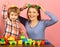 Family with cheerful faces build out of colored construction blocks.