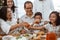 Family cheering during lunch together at home