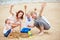 Family cheering in summer on beach