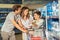 Family with child and shopping cart buying water in store or supermarket