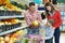 Family with child shopping fruits