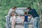 Family with children discusses a paper card during a family trip