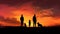 Family with children and dog silhouetted against a colorful sky