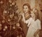 Family with children dressing Christmas tree.