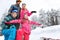 Family with children enjoying on winter vacation in snowy nature