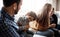 Family, children and a father tickling his son in the living room of their home together with mom and brother in the