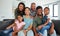 Family, children and love with kids, grandparents and parents sitting on a sofa in the living room of their home during