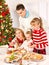 Family with children rolling dough in Xmas