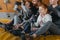 Family with children sitting on a mat at gym with climbing walls