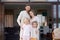 Family with children standing on terrace of new house