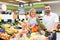 Family choosing fruits in hypermarket