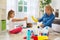 Family cleaning room smiling and having fun