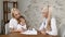 Family clinic. Pretty mother and her female kid in doctors office.Child drawing while mother and doctor talking. General