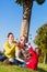 Family collecting chestnuts on bicycle trip