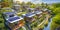 Family colorful houses in neighborhood with green trees, Aerial View of Sustainable settlement