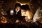 Family concept. Mother and child daughter reading book with flashlight together in children tent before bedtime. Happy mother read