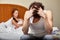 Family conflict. Young couple quarrels in bedroom at home.  Selective focus on woman