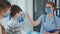 family consults the physician in hospital office, medical doctor in mask and glasses measures the temperature of boy