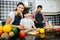 Family cooking time : Happy mum teach her daughter chopping vegetable preparing ingredients for cooking meal in kitchen