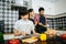 Family cooking time : Happy mum teach her daughter chopping vegetable preparing ingredients for cooking meal in kitchen