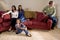 Family on couch with father sitting apart