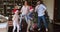 Family couple with children dancing near Xmas tree at home