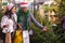 Family couple choosing christmas tree at christmas fair