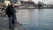 Family Couple Feeding Gulls from the Shore