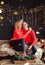 Family couple kiss and hugging on holiday. Living room decorated by Christmas tree and present gift boxes. Portrait loving family