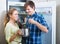 Family couple opened fridge and looking food