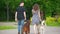 Family couple with pets dogs walking in park - man and woman walks with irish setter and husky