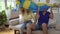 Family couple of sports fans at home with the flag of Sweden. Football fans of the Swedish national team are watching TV