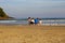 A family with a couple and two children squatting in front of the sea. Riviera beach, Bertioga, Brazil