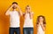 Family Covering Eyes, Ears And Mouth, Yellow Background In Studio