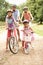 Family Cycling In Countryside Wearing Safety Helme