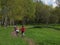 Family cyclists on a walk in the park.