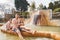 Family, dad and children bathe, swim in outdoor dirty hot springs. Thermal water bath pool and healthy natural, clay and