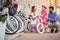 Family with daughter having fun outdoor shopping new bicycle