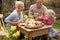 Family Decorating Easter Eggs On Table Outdoors