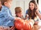 Family decorating pumpkins together for Halloween