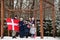 Family with Denmark flags outdoor in winter. Travel to Scandinavian countries. Happiest danish people`s