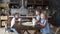 Family dinner: Three children at the kitchen table eating buns and drinking tea.