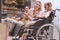 family with disabled child in wheelchair playing with joysticks together