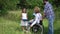 Family with disabled mother outdoors.