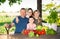 Family discusses the harvest of vegetables at the table of the village house